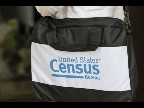 
A census taker’s briefcase is visible as she knocks on doors on August 11, 2020, in Winter Park, Florida.  A report released on Tuesday, July 9, 2024 by the American Statistical Association warns that US statistical agencies lack protections against pol