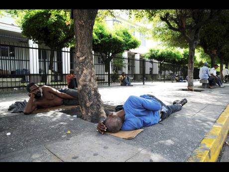 In this 2011 photo, homeless men are seeing resting on the sidewalk in front of the Supreme Court, downtown Kingston. Kristen Gyles writes: ‘Nonetheless, our efforts to address the issue of homelessness have fallen short, especially among the mentally il