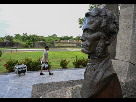 In this 2022 photo Perry Burnette is seen walking by Sir George William Gordon’s bust. 