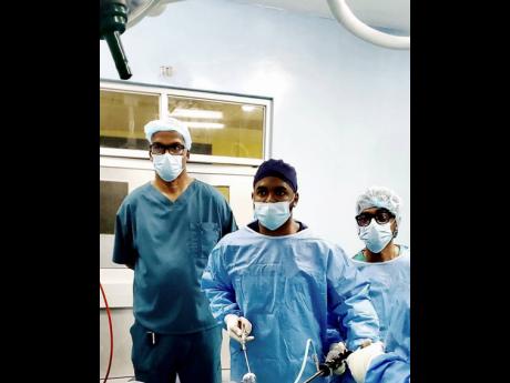 
Dr O’Rane Thomas is flanked by Dr Douglas Jefferson (left), consultant general surgeon, May Pen Hospital and Dr Dale Laws, senior registrar in general surgery.