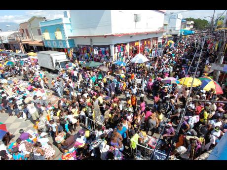 This file photo shows shoppers in downtown Kingston. Ronald Thwaites writes: The big salary increases, especially for the overlords, are causing revulsion among ordinary folk as they struggle with the peril of Beryl on top of the already punishing cost of 