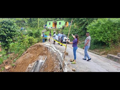 Portland Eastern Member of Parliament Ann-Marie Vaz (second right) examining the breakaway at Ginger House in the constituency on Sunday.