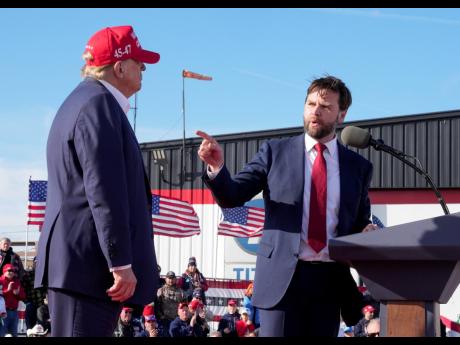 Senator J.D. Vance points to Republican presidential candidate, former President Donald Trump, at a campaign rally in Vandalia, Ohio, on March 6. 