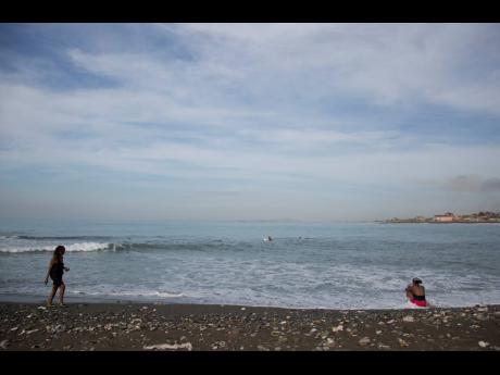 People gather on Wickie Wackie Beach in Kingston, Jamaica, October 2, 2016.