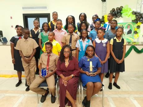 Hanover Western Member of Parliament Tamika Davis (seated front, centre) sharing a moment with the Primary Exit Profile (PEP) top performers for 2024 from that constituency at an awards function at Grand Palladium Hotel in Hanover. Seated to the MP’s rig