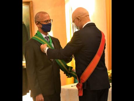 In this December 2020 file photo, Governor General Sir Patrick Allen (right) presents the instrument of appointment to Justice Patrick Brooks after he was sworn in as president of the Court of Appeal at King’s House.