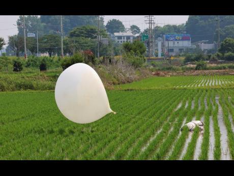 A balloon presumably sent by North Korea, is seen in a paddy field in Incheon, South Korea, on June 10.