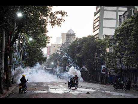 Police officers fire tear gas during a protest in Nairobi, Kenya on Tuesday.