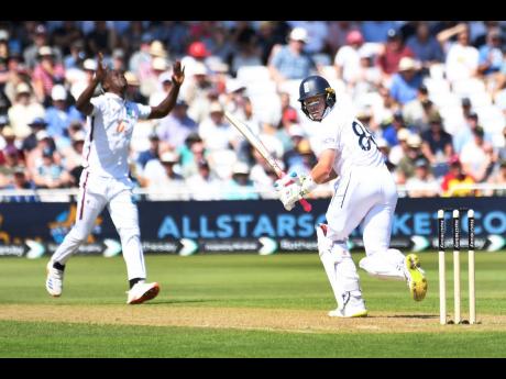 West Indies pace bowler Shamar Joseph gestures as England’s Ollie Pope plays a shot during day one of the second Test at Trent Bridge cricket ground, Nottingham, England, yesterday.