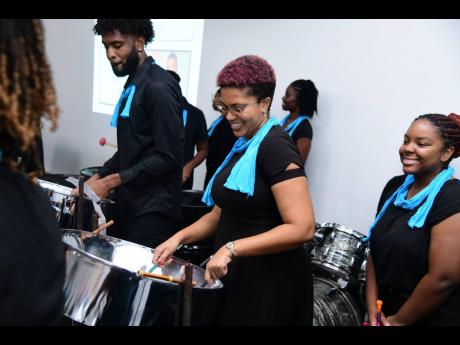 Akilah Sykes and the UWI Panoridim Steel Orchestra kept the live entertainment afloat during the charity auction.