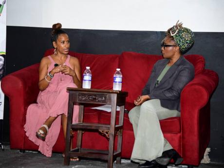 Charl Baker (left) and Stephanie Marley discuss the constitution at the launch of the Art for Liberation Poetry and Visual Arts Competition on July 10. 