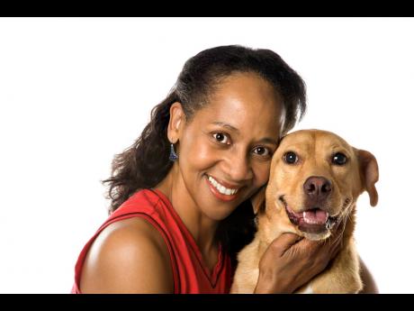 Representational image of a woman posing with a dog.