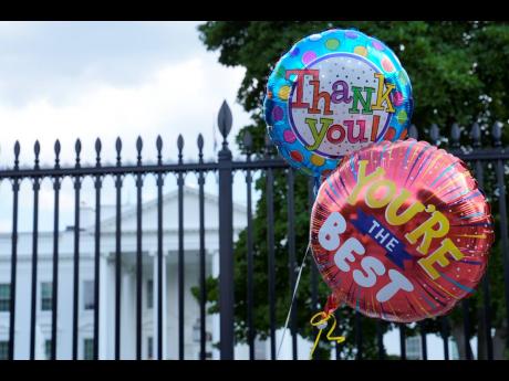 Balloons for United States President Joe Biden are brought to the White House in Washington, DC, on Sunday.