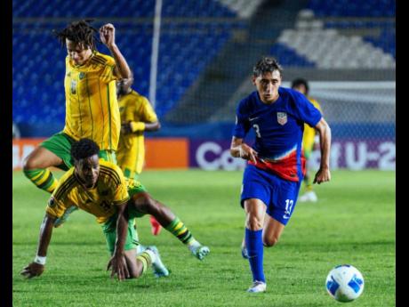 Jamaica’s Nashon Bolt (second left) and Rashaun Small (left) get in each other’s way as the United States’ Cruxz Medina runs away with the ball during a Concacaf Under-20 Championship game at the Estadio Miguel Alemán Valdés in Celaya, Mexico, on F