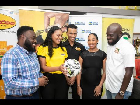 Kristina Hill (second left), brand manager, beverages, Grace Foods, represents title sponsor Grace Mighty Malt in a photo op during the media launch for the Victory Cup football tournament organised by ProNation Sports. Joining Hill in conversation are (fr