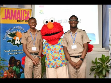 Beaches’ Sesame Street character, Elmo, congratulates the winner, Tal Melbourne (left), and runner-up Hassan Smith after the competition.