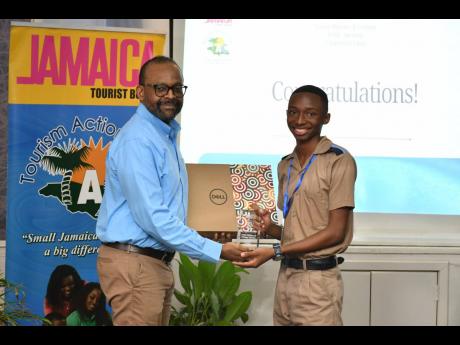 Keynote speaker Donovan White, director of tourism, presents Taj Melbourne with his winner’s plaque and a Dell laptop at the end of the competition.