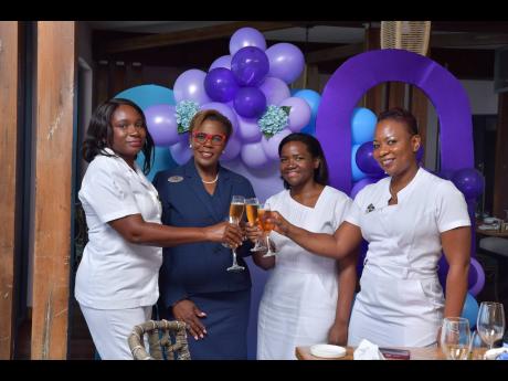 Nurse Bobbet Gibbs-Enyi (left) and Marja-Ann Wright (right) of Falmouth Hospital share a toast with Dawn Smith (second left), Sandals Royal Caribbean general manager, and Nurse Keisha Shaw of Cornwall Regional Hospital at the start of an appreciation lunch