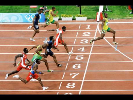 Jamaica’s Usain Bolt (right) crosses the finish line to win gold in the men’s 100 metres in a world record 9.69 seconds at the 2008 Beijing Olympics.