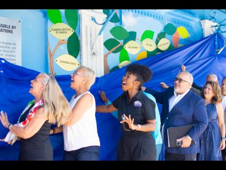 Andrea Dempster Chung (centre) and donors unveiling a new mural in downtown Kingston which includes plaques with the names of donors who have assisted with the initiatives of Kingston Creative. The unveiling took place on Wednesday, July 24, following the 