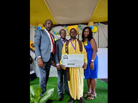 Jowayne Johnson (second right), 2024 winner of the Teacher C.C. Brown Academic Scholarship, poses with his symbolic cheque for $75,000. From left are Superintendent of Police Leighton Blackstock, chairman of the Rock Primary Past Students Association; prin