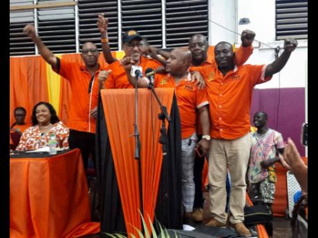 Dr Wykeham McNeill (in cap at podium), surrounded by councillors and prospective councillors from Trelawny North after he was installed as the People’s National Party’s caretaker and prospective candidate for the constituency on Sunday. 