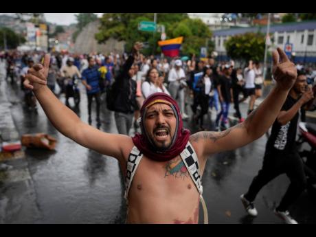 People protest the official results declaring President Nicolas Maduro was re-elected,on Monday, July 29,  the day after the vote in Caracas, Venezuela.