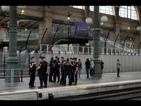 FILE - Police officers patrol inside the Gare du Nord train station at the 2024 Summer Olympics, Friday, July 26, in Paris, France. 