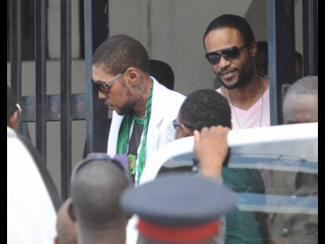 Entertainers Vybz Kartel and Shawn Storm leave the Home Circuit court where they were sentenced to life imprisonment on April 3, 2014.