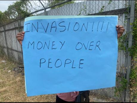 One of the placards held by a protester in Richmond Park, St Andrew on Monday.