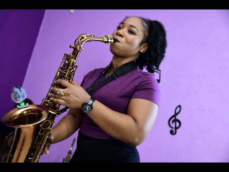 Instrumentalist Andrene Brown playing a piece on her saxophone.