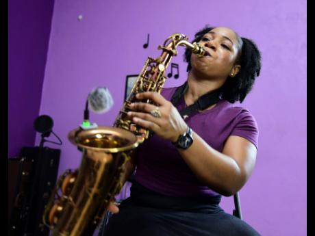 Instrumentalist Andrene Brown playing a piece on her saxophone.