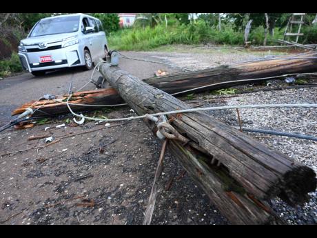 A downed light post in Resource district, Manchester, two days after the passage of Hurricane Beryl.