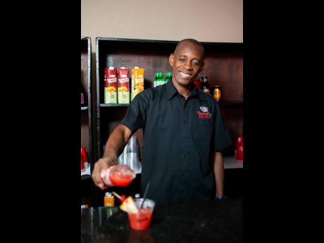 Cheers to that! Byron Francis, mixologist, pours a refreshing Grace Tropical Rhythms cocktail.