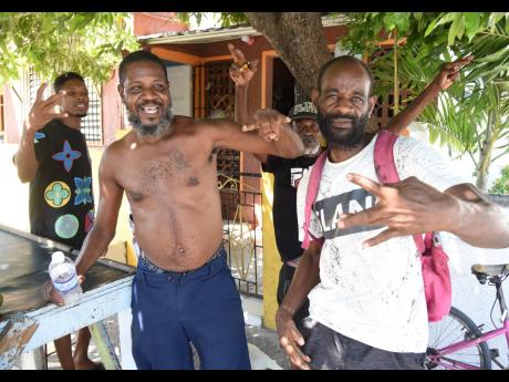 Supporters of dancehall entertainer Vybz Kartel show off the Gaza sign while celebrating the ruling handed down by the Court of Appeal yesterday.