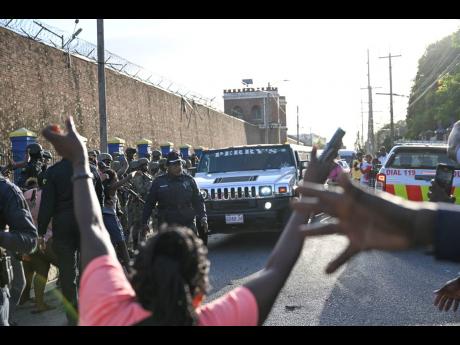 Fans gather on Tower Street to see the limousine with dancehall superstar Vybz Kartel leaving the Tower Street Adult Correctional Facility.