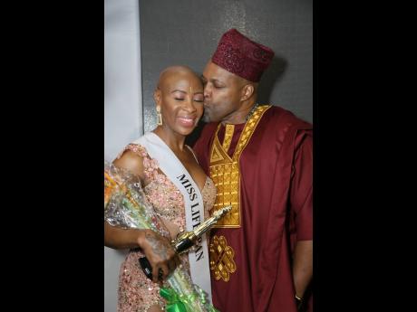 Dr Sandra Swaby (left) is congratulated by her husband Garth Swaby post-coronation. 