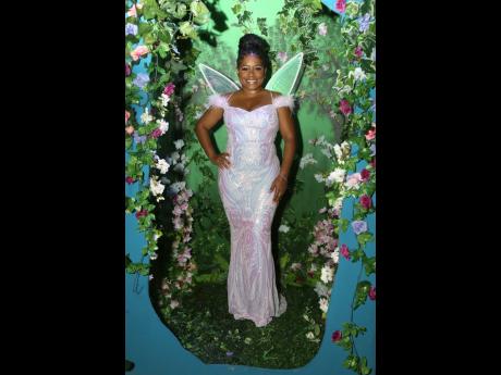 Shanique Sinclair, the curator of the event, lives up to her moniker ‘Shanz the Book Fairy’, enchanting the evening in an iridescent dress paired with delicate fairy wings.