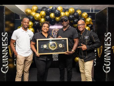 Guinness junior brand manager Lasana Wilson (left), Guinness brand manager Nadine Hylton (second left), and Red Stripe head of commerce Sean Wallace (right) presented Esran Phillips, popularly known as ‘Billy Slaughter’, with the 2024 Guinness Recognit