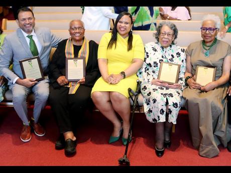 Deputy Chief of Mission at the Jamaican Embassy  Lishann Salmon (centre) shares a light moment with the Jamaica Diaspora 2024 DMV honorees – from left; Loriston Sindass ,  Linda Gatling, Carmen Edwards, and  Doreen Thompson.