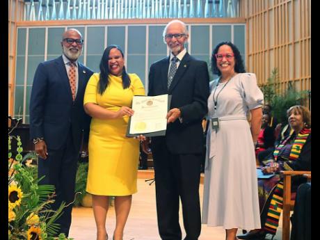 Deputy Chief of Mission at the Jamaican Embassy Lishann Salmon (centre) accepts a Proclamation from Governor  of Maryland Wes Moore presented by Chairman of  the Maryland Commission on Caribbean Affairs Ambassador Curtis Ward.  Looking on from left; are Co