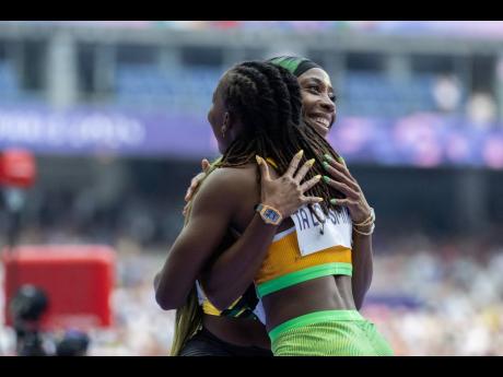 Jamaica’s Shelly-Ann Fraser-Pryce (left) hugs Marie-Josée Ta Lou of the Ivory Coast moments after placing second to Ta Lou’s 10.87 season’s best in heat 8 of the women’s 100m qualifiers at the Stade de France in Paris, France, on Friday.