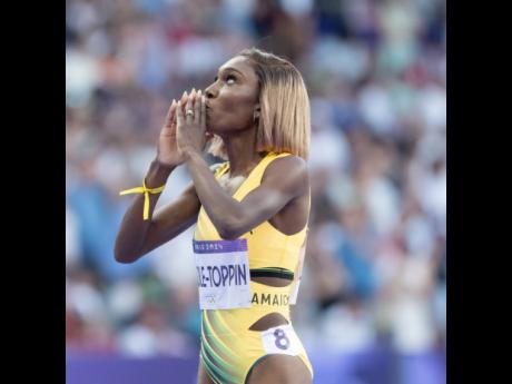 Below: Natoya Goule Toppin celebrates her win in the women’s 800m round 1 heat 6 at the Stade de France in Paris, France, on Friday.