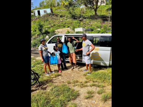 Randy Griffiths, founder of Pencils4Kids, delivering care packages for the elderly and children in Quickstep, St Elizabeth.