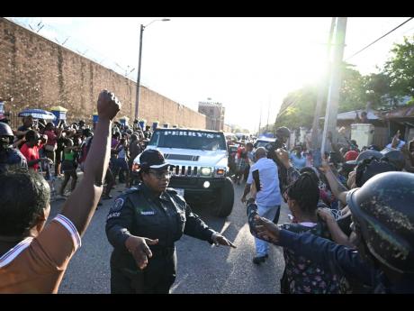 Supporters of dancehall artiste Vybz Kartel in a celebratory mood as he leaves the Tower Street Adult Correctional Facility, after being set free by the Court of Appeal.