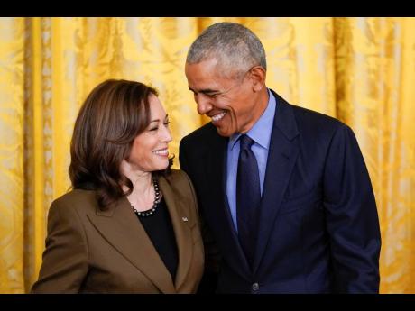 Former President Barack Obama talks with Vice President Kamala Harris.