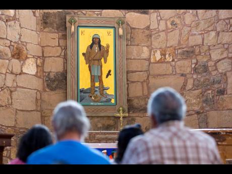 The Apache Christ painting hangs behind the altar of St Joseph Apache Mission church in Mescalero, New Mexico on July 13. The painting, an icon that depicts Christ as a Mescalero medicine man, was the forefront of a tension-filled episode between the commu