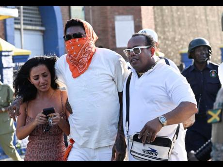 
Dancehall artiste Vybz Kartel (centre), real name Adidja Palmer, leaving the Tower Street Adult Correctional Centre in downtown Kingston last Wednesday, moments after the Court of Appeal ruled against a retrial after his murder conviction was quashed earl