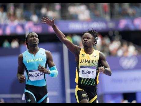 Ackeem Blake (right) competing in the men’s 100m heats at the Stade de France in Paris, France, yesterday.