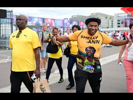 Jamaican track and field fans arrive at the Stade de France in Paris, France, yesterday.